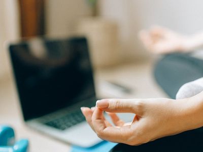 A person sitting calmly on a mat after a workout session.